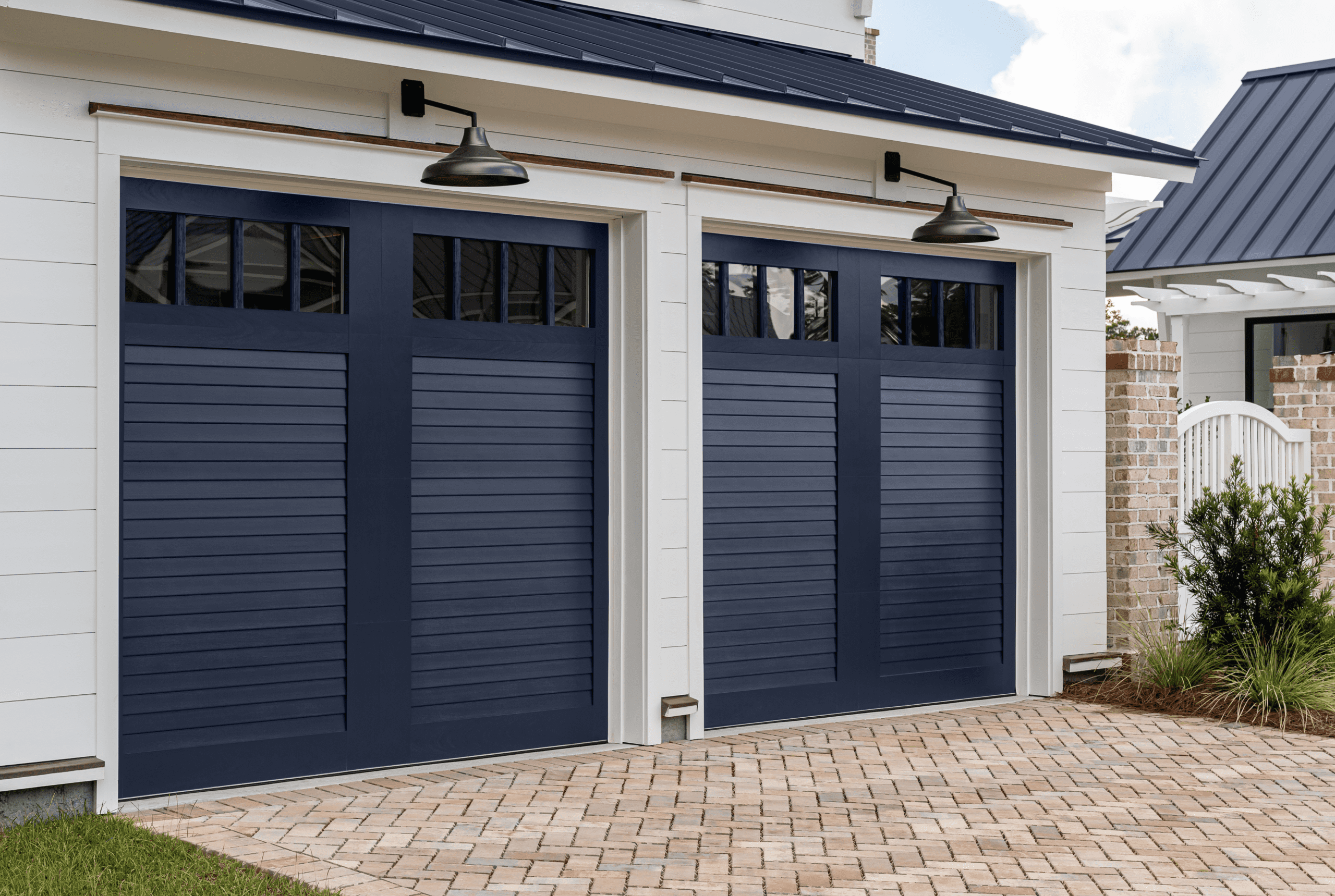 Clopay Canyon Ridge Louver Design 52 in a Customer Color (Sherwin-Williams SW 2739 Charcoal Blue) with Louver Mahogany Cladding & Overlays with Clear Glass REC14 Windows