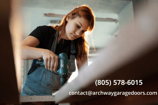 Malibu technician performing coastal garage door repair and rust protection to prevent salt damage — Archway Garage Doors.